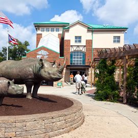 A statue of rhinos in front of a building.
